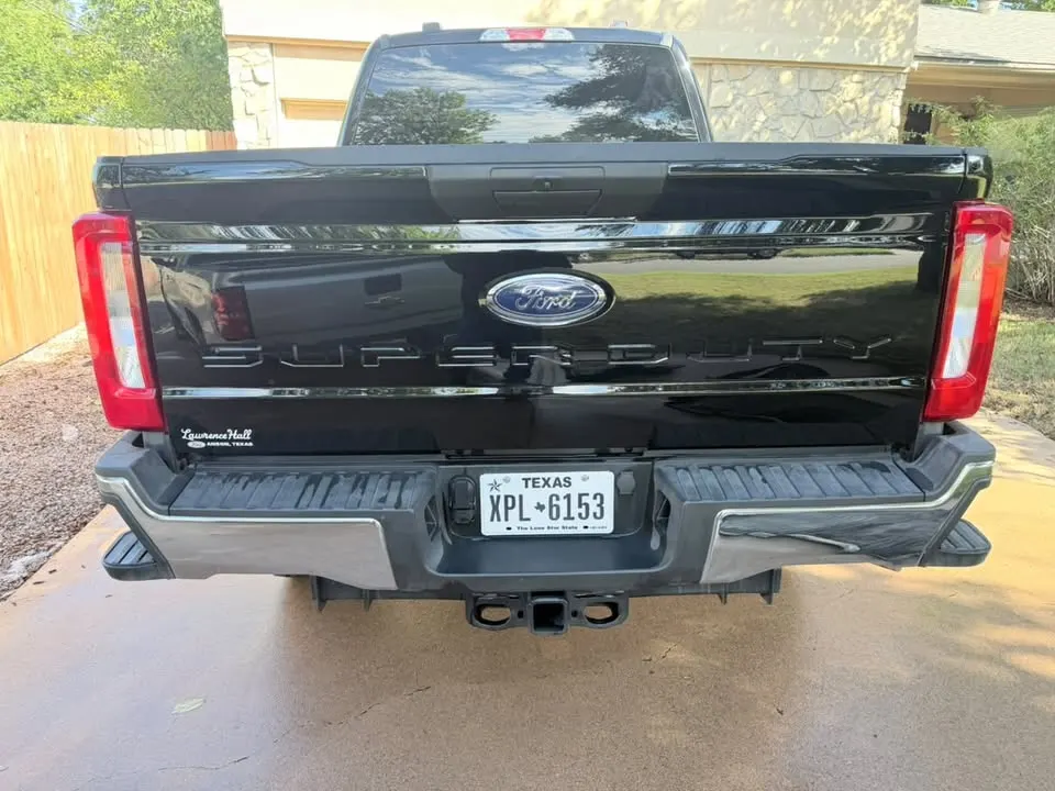 Black Ford truck, rear view, freshly washed