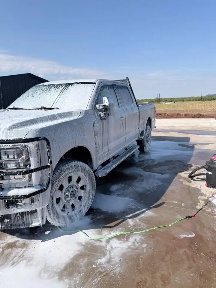 Grey truck in foam during a hand wash